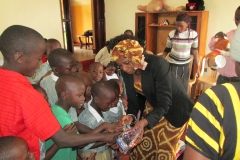 Kay handing out toys to the boys at Uganda orphanage